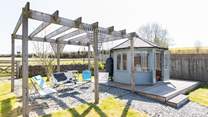 Take your pick of a seat under the pergola or in the summer-house.