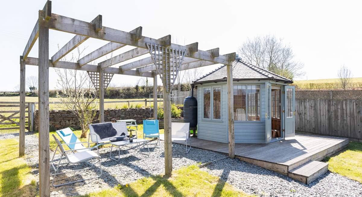 Take your pick of a seat under the pergola or in the summer-house.