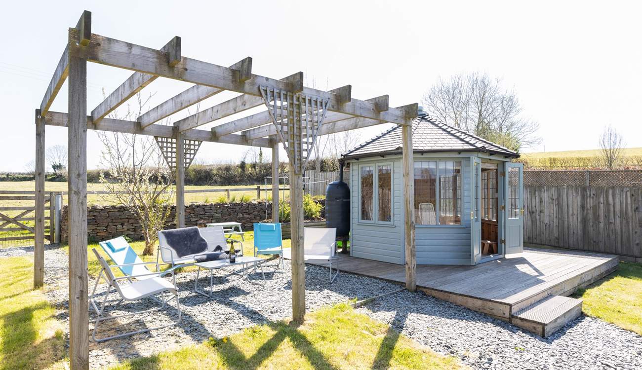 Take your pick of a seat under the pergola or in the summer-house.