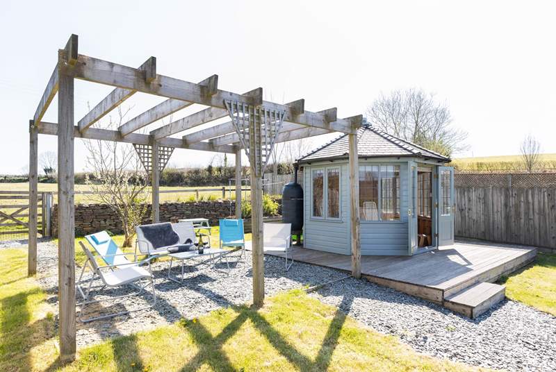 Take your pick of a seat under the pergola or in the summer-house.
