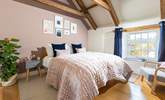 The luxurious main bedroom with characterful exposed beams. - Thumbnail Image