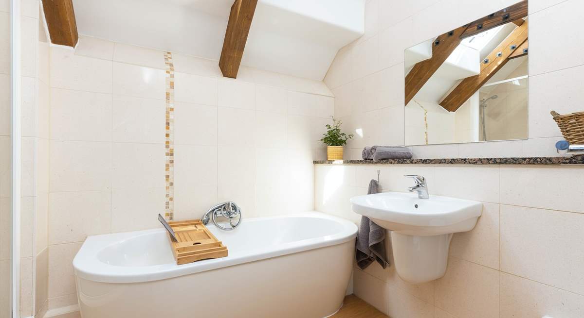 The family bathroom with exposed beams is lovely.