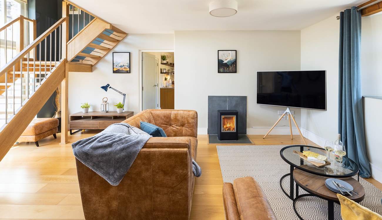 The fabulous sitting-room with floor to ceiling windows is the perfect place to relax.