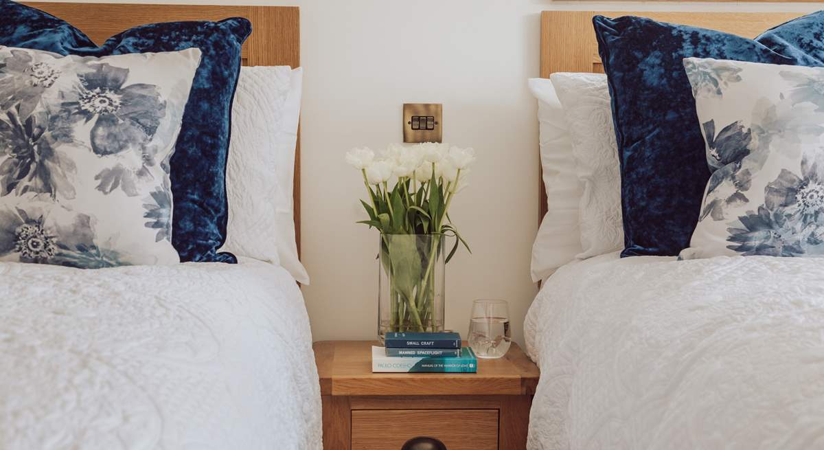 Lovely linens and cushions adorn the beds.