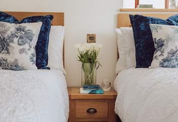 Lovely linens and cushions adorn the beds.