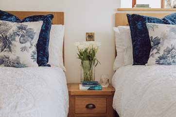 Lovely linens and cushions adorn the beds.
