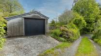 Your garage and sloped parking. Note, the driveway and parking space are recommended for small to medium cars only (due to the width of the approach and space).