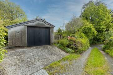 Your garage and sloped parking. Note, the driveway and parking space are recommended for small to medium cars only (due to the width of the approach and space).