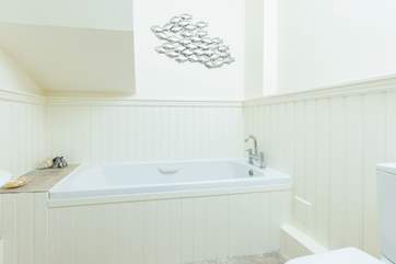 The bath in the en suite bathroom for bedroom one.