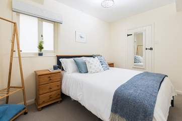 Bedroom two has a king-size bed, storage and an en suite shower-room.