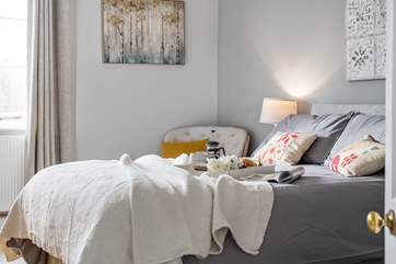 Stylish linens adorn this lovely bed.