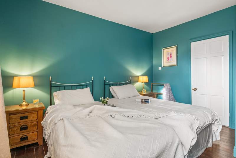 Bedroom four is beautifully furnished with twin beds.