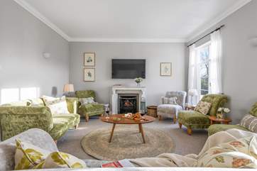 The principal sitting room in all it's glory with a glorious roaring fire!