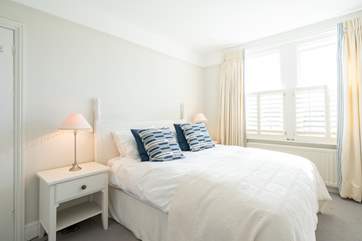 The spacious second bedroom with views overlooking the rear of the property.
