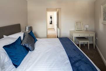 The main bedroom is home to this super comfy bed.