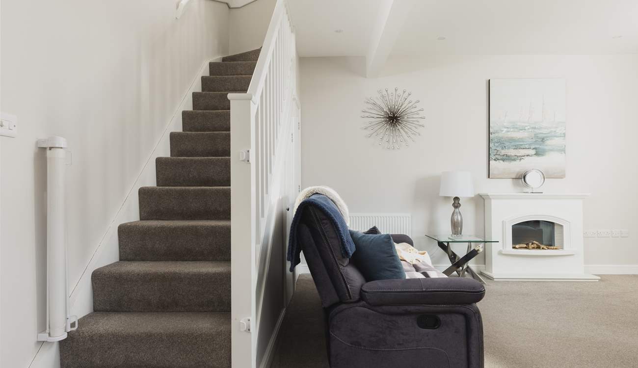 The stairs lead off up from the sitting/dining-room.