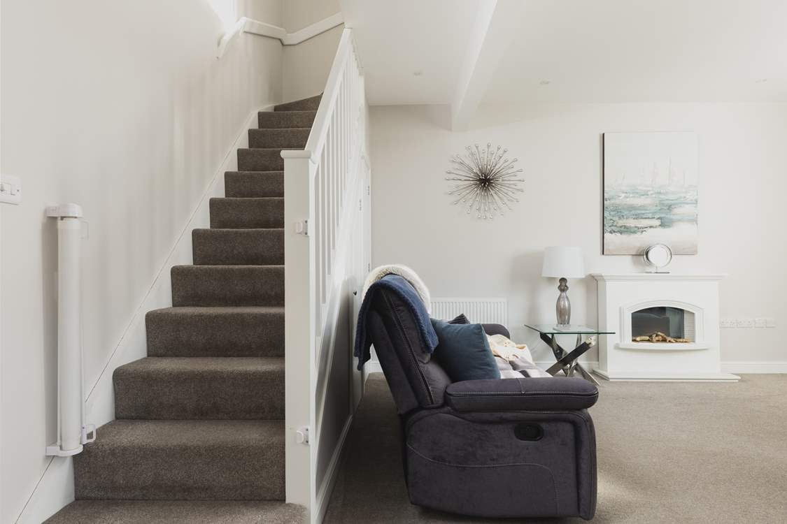 The stairs lead off up from the sitting/dining-room.