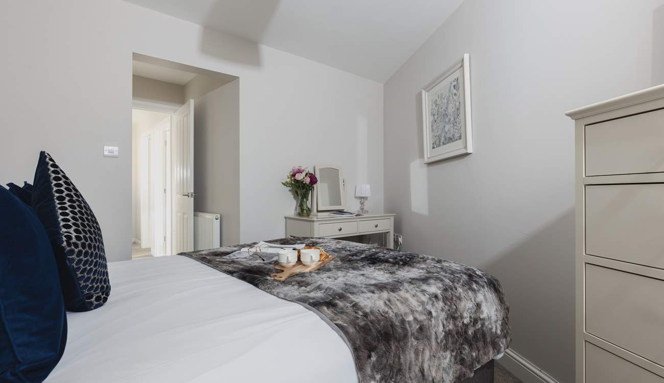 The main bedroom is home to this super comfy bed.