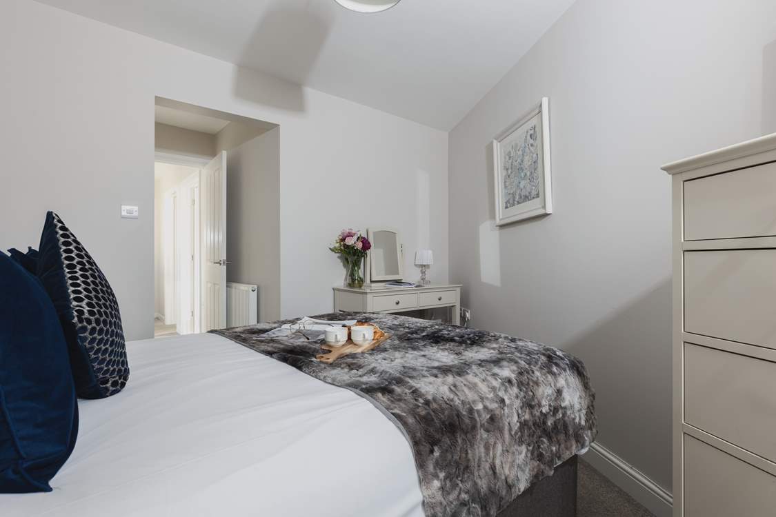 The main bedroom is home to this super comfy bed.