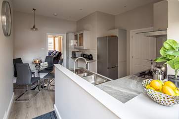 The kitchen leads into the living area.