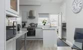 The kitchen is light, airy, and fully equipped for whipping up a feast. - Thumbnail Image