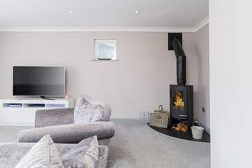 The comfortable sitting-room has a toasty wood-burner.