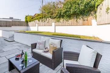 The garden area has a table, sofa and chairs in the summer and is perfect for al fresco drinks before supper.