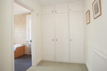 The dressing-room off the suite with a door to an en suite bathroom.