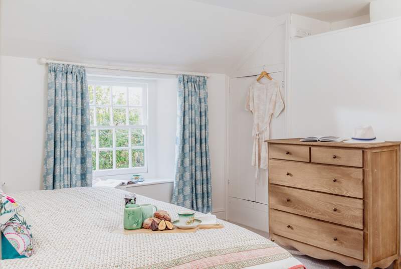 The main bedroom has charming interiors decorated with gentle blue tones and thoughtfully selected vintage furniture.