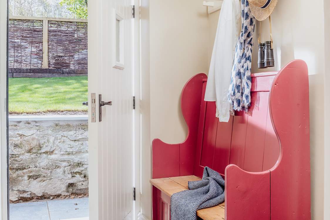 Arrive into a large hallway, with ample space for all of your holiday kit from welly boots to wetsuits, buckets to beach balls.