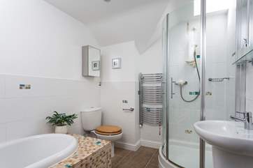 The main bathroom with a shower and bath (there is a small step getting in the shower).