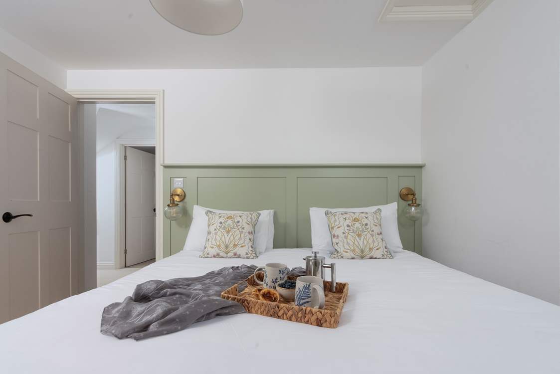 We adore the gorgeous panelling and bedside lamps.