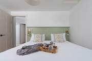 We adore the gorgeous panelling and bedside lamps.