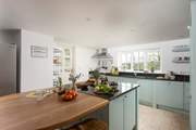 A door leads from the kitchen out to the terrace and garden.