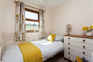 Two steps lead up to pretty bedroom three where you will find a super-comfy day bed.