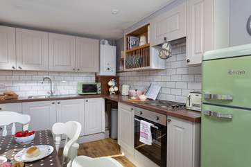 The lovely kitchen has ample units.