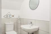 A convenient cloakroom with WC is located on the ground floor.