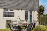 The sweet south-facing garden space is laid with artificial grass, perfect for little ones to play on. (please note the wall is low)