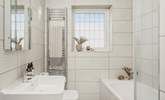 The contemporary family bathroom is also located on the first floor, the lovely bath is perfect for soaking in and daydreaming after a long day exploring Cornwall.  - Thumbnail Image