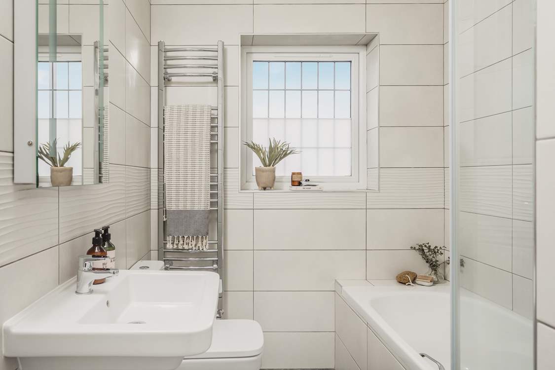 The contemporary family bathroom is also located on the first floor, the lovely bath is perfect for soaking in and daydreaming after a long day exploring Cornwall.