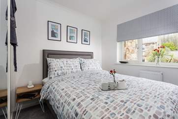 The main bedroom boasts a king-size bed, and crisp luxury linens.