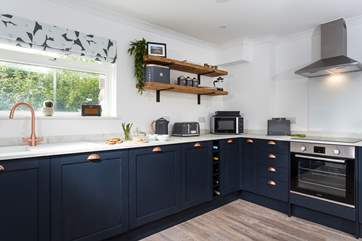 The gorgeous kitchen is very well-equipped.