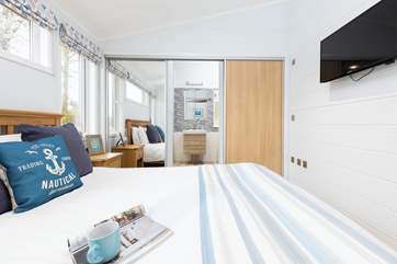 The main bedroom has a wonderful en suite shower, which is hidden behind the wardrobe doors.