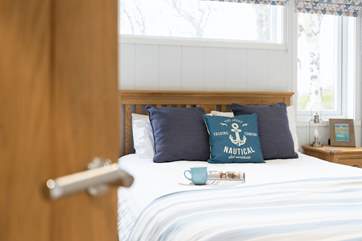 The main room floods with light thanks to a clever apex window from the living area.