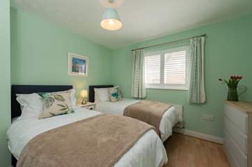 The twin room has soft linens and cosy throws.