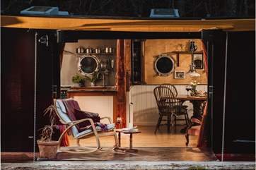 Sit upon the hull door as the sun begins to fade.