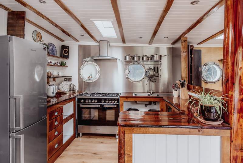 Spacious kitchen with handcrafted worktops from recycled Falmouth dock pilings.