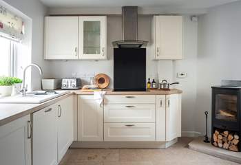 The fully equipped kitchen with the perfectly placed wood-burner.