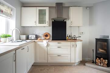 The fully equipped kitchen with the perfectly placed wood-burner.