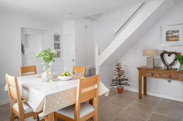 The formal dining area sits central to the house with stairs up to the first floor.